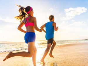 Joggers running at the beach on Oahu. Counseling combined with exercise can improve mental health for many Hawaii residents.