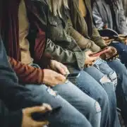 Teens in Hawaii on smartphones. Social media addiction.